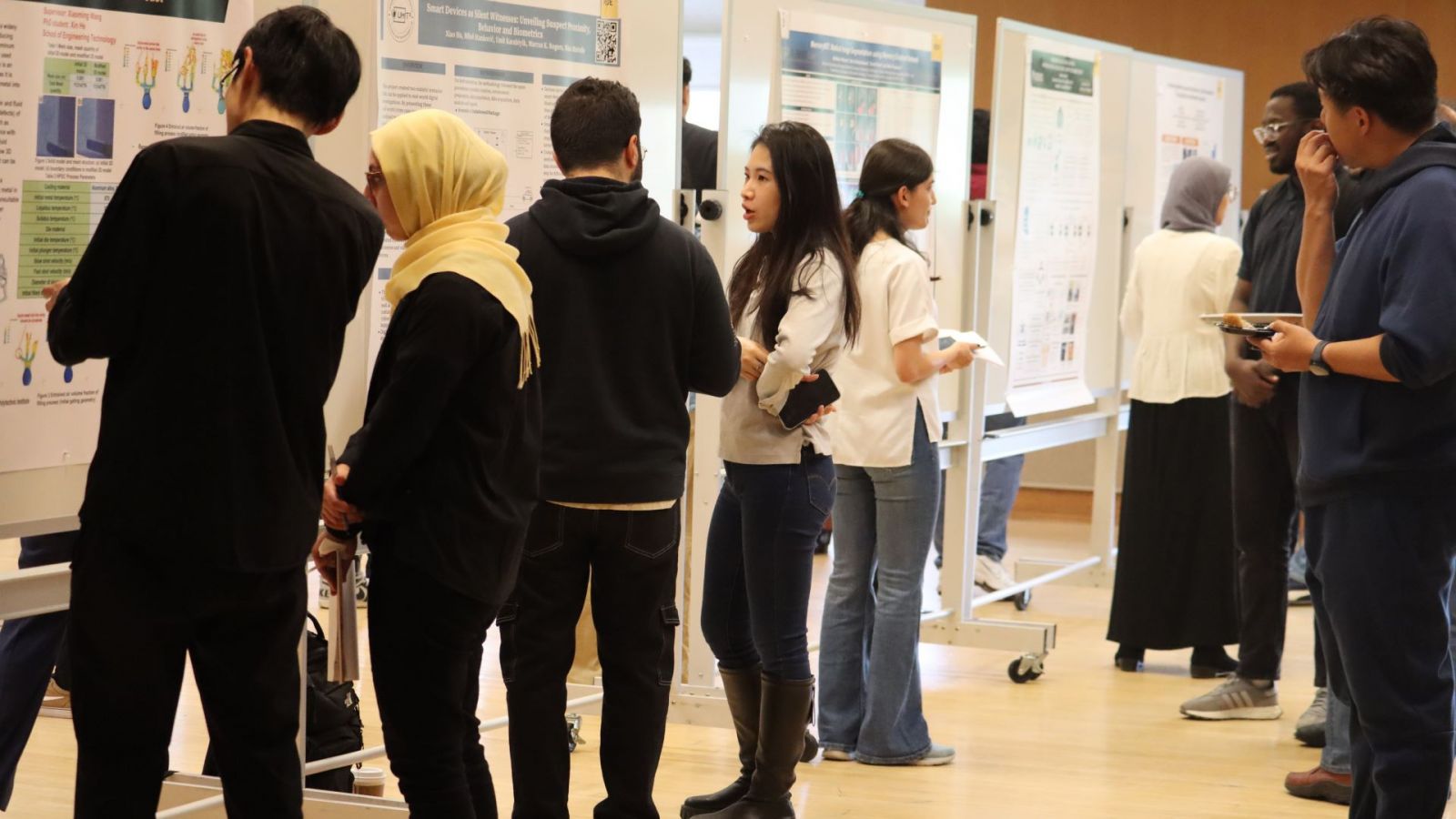Students discuss each others' work at the spring 2024 graduate-level poster competition. (Purdue University photo/John O'Malley)