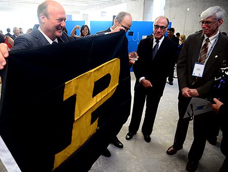 Eduardo Hochschild, founder of the UTEC, accepts a Purdue flag from College of Technology Dean Gary Bertoline. (courtesy photo)