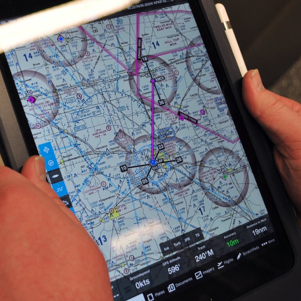 The Electronic Purdue Bag’s iPad screen displaying a VFR (Visual Flight Rules) Sectional Chart. The pink line indicates the direct course between airports. The app also allows users to overlay weather conditions and other data.