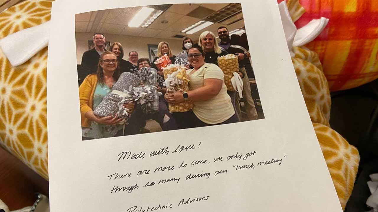 The Purdue Polytechnic Institute’s academic advising staff left a kind note for LaGrange atop their blanket donation. Pictured: Tami Lynch, T.R. Oneal, Aimee Griggs, Angie Murphy, Zach Oborne, Cassie Pendleton, Susan Hockings, Melody Carducci, Heather Mayorga, and Jill Lloyd-Crucini. The note reads, "Made with love! There are more to come. We only got through so many during our 'lunch meeting.' —Polytechnic Advisors" (Photo provided)