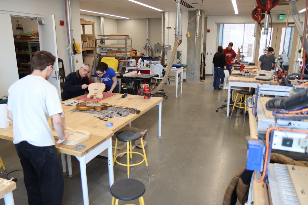 Students working in the Guitar Lab, with oversight by Mark French. (Purdue University photo/John O'Malley)