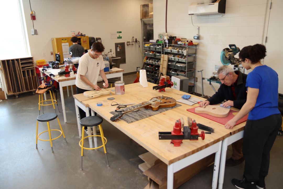 Students working in the Guitar Lab, with oversight by Mark French. (Purdue University photo/John O'Malley)