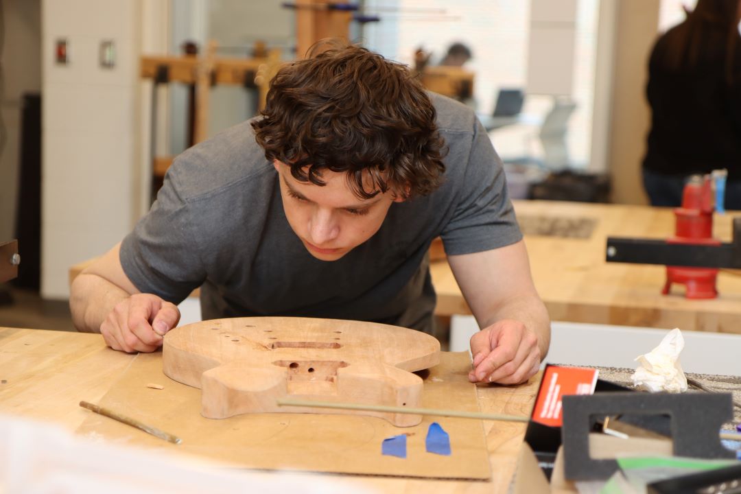 Students working in the Guitar Lab, with oversight by Mark French. (Purdue University photo/John O'Malley)