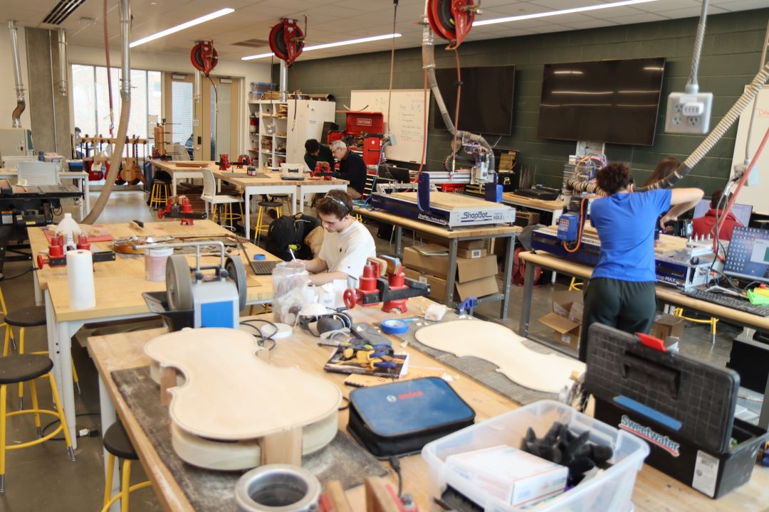 Students working in the Guitar Lab, with oversight by Mark French. (Purdue University photo/John O'Malley)