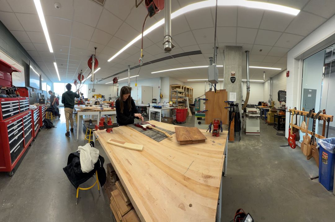 Students working in the Guitar Lab, with oversight by Mark French. (Purdue University photo/John O'Malley)