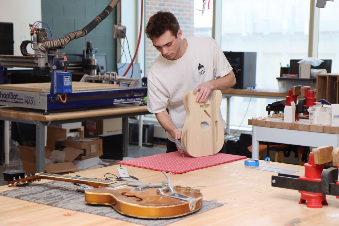 Students working in the Guitar Lab, with oversight by Mark French. (Purdue University photo/John O'Malley)