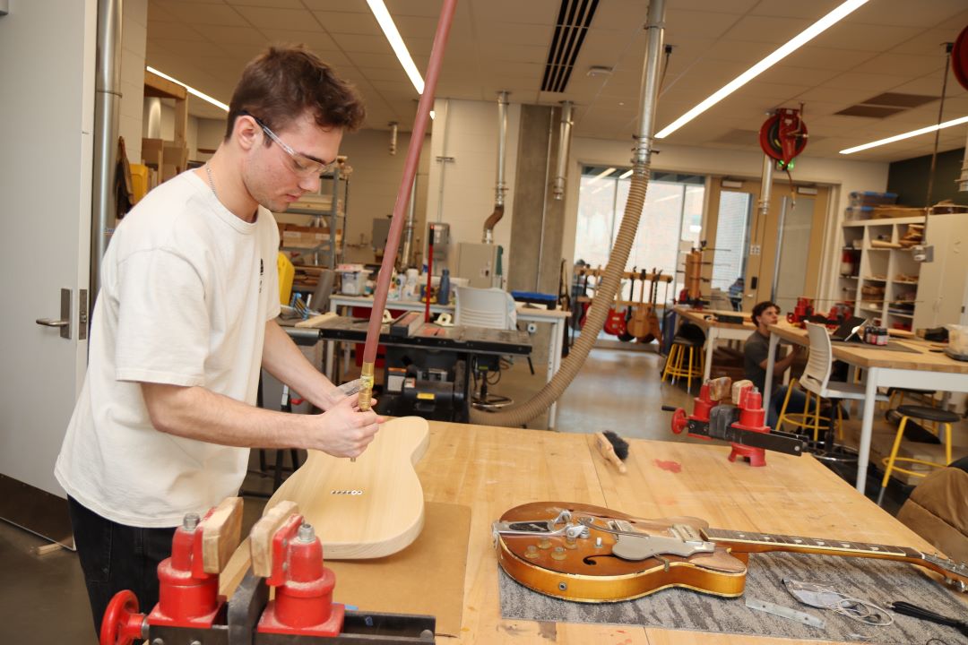 Students working in the Guitar Lab, with oversight by Mark French. (Purdue University photo/John O'Malley)