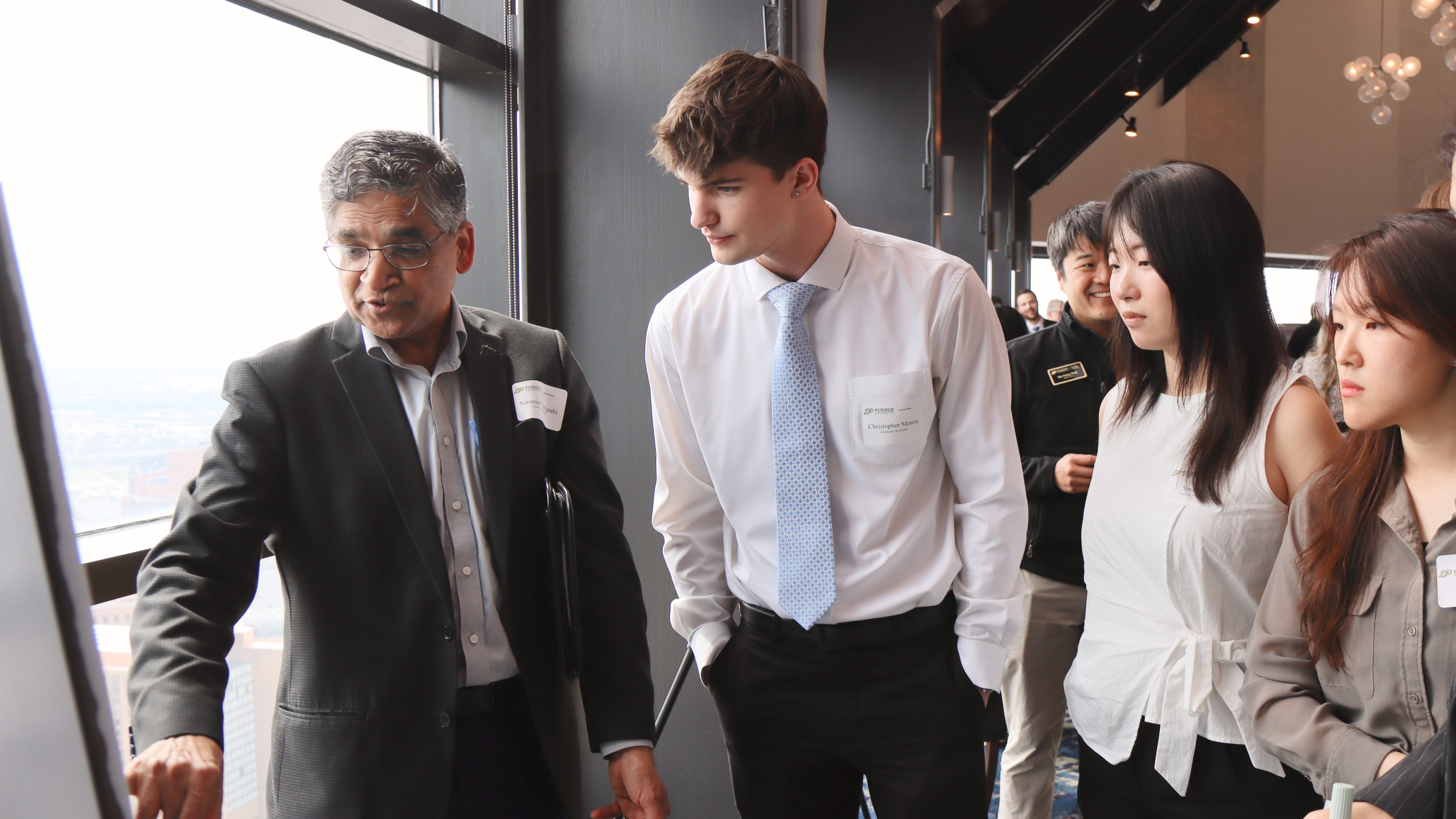 Suranjan Panigrahi speaking to attendees during the poster session. (Purdue University photo/John O'Malley)