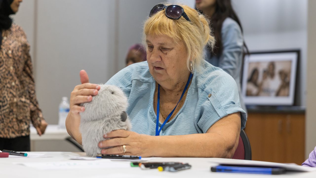 A participant in the AI companion workshop interacts with Moflin, a companion which is currently on the market. Photo: Anthony Gollab/University of Houston. (ELARA Lab study at Mamie George Community Center)