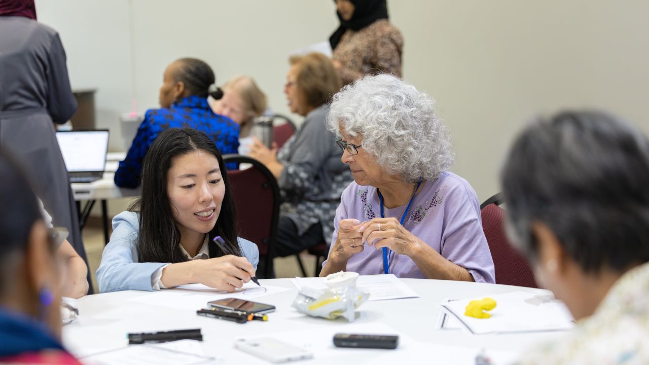 Park takes feedback from a participant in the AI companion workshop at the Mamie George Community Center. Photo: Anthony Gollab/University of Houston. (ELARA Lab study at Mamie George Community Center)
