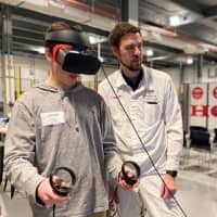 Students from Jobs for America’s Graduates (JAG) Region 9 using virtual reality forklift simulation in the HMIN Drives Dreams Pathway with HMIN’s Brandon Parker.