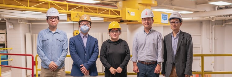 Yifu Wu (graduate research assistant), Jiansong Zhang (co-principal investigator), Jin Wei-Kocsis (principal investigator), Byung-Cheol “B.C.” Min and Dongming Gan (co-principal investigators), standing in Knoy Hall’s D. Dorsey Moss Construction Lab with an unmanned aerial vehicle and a robotic vehicle