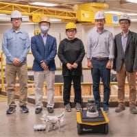 Yifu Wu (graduate research assistant), Jiansong Zhang (co-principal investigator), Jin Wei-Kocsis (principal investigator), Byung-Cheol “B.C.” Min and Dongming Gan (co-principal investigators), standing in Knoy Hall’s D. Dorsey Moss Construction Lab with an unmanned aerial vehicle and a robotic vehicle