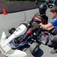 A student driver prepares to test his team's electric go-kart.