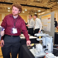 A student presents his capstone project at the Purdue Polytechnic Tech Expo