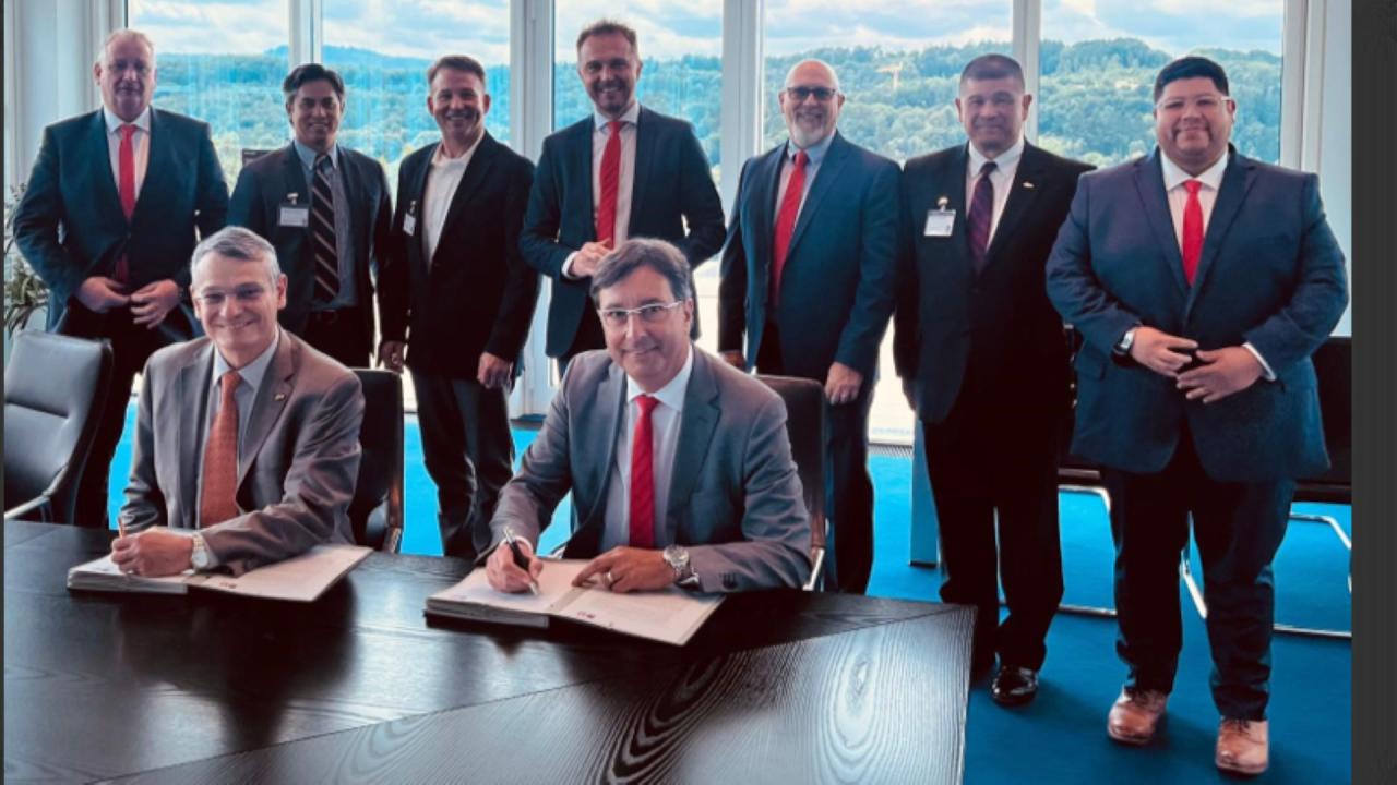 Dean Daniel Castro (left) signing an agreement on the upcoming partnership in Germany with Purdue Development staff. (Photo provided)