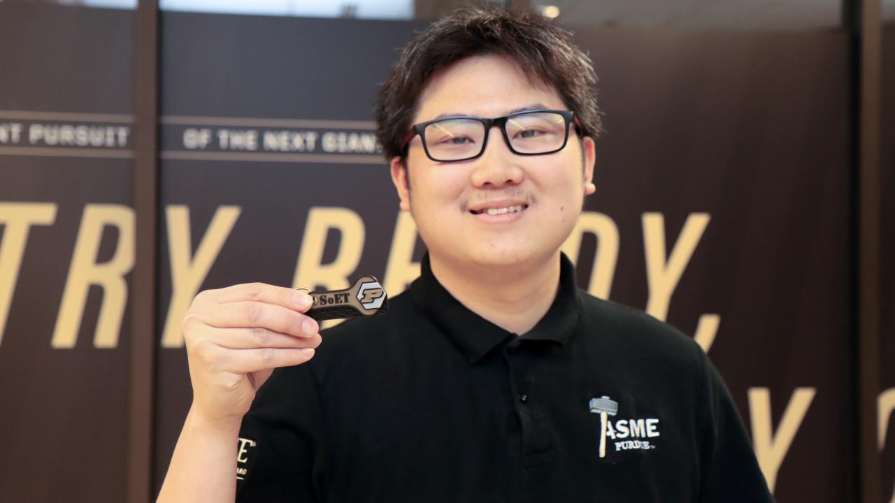Tuan Thai pictured with his winning keychain design. (Purdue University photo/John O'Malley)