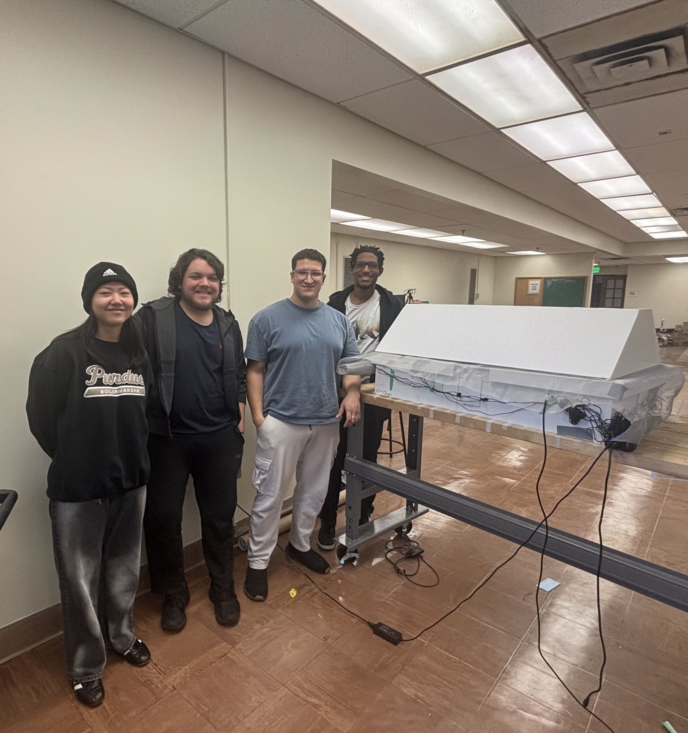 Members of Team 4 stand in front of the enclosure.