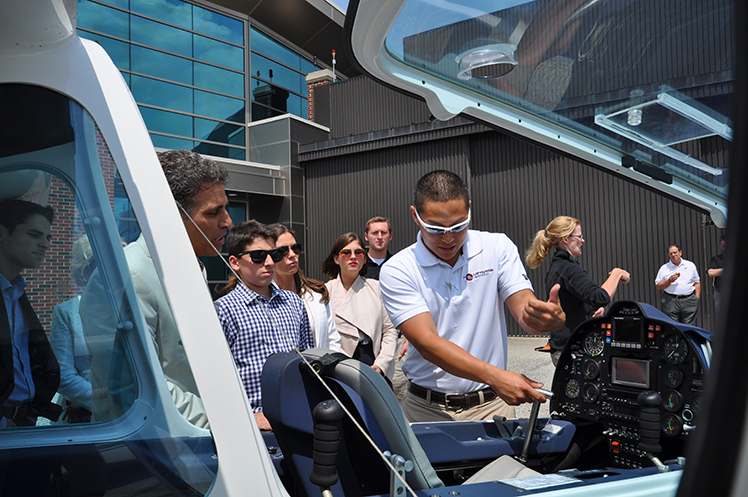 Flight instructor Kirk Choquette shows members of the Ricci Family Foundation the features of a Sky Arrow L600 sport plane.