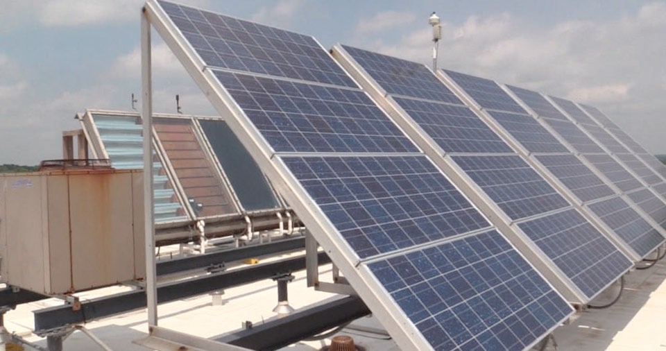 Solar thermal systems (back row) and solar photovoltaic panels on Knoy Hall's rooftop