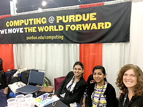 Tanmayee Kamath, Prachita Mane and Prof. Dawn Laux staff the Computing @ Purdue table at GHC.