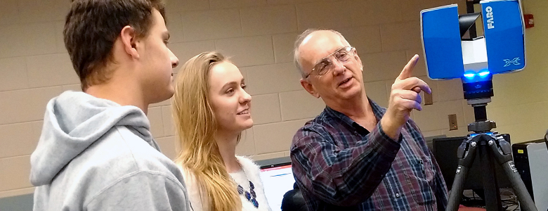 Wes Crawford (right) demonstrates how to operate the Faro 3D scanner to students Brad Cruse and Anna Voyles. The scanner can capture all aspects of a construction project from start to finish. Many owners are requiring this information so, if they want to add to the structure, they will know exactly where every stud, pipe, and wire are located.