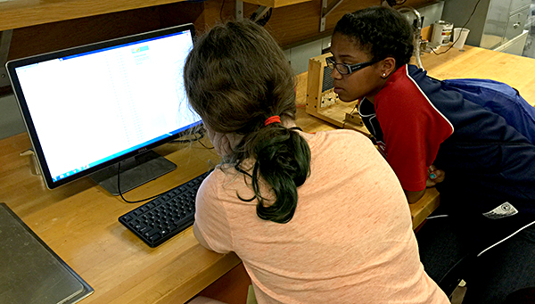 Students learn about computing concepts during a college camp.
