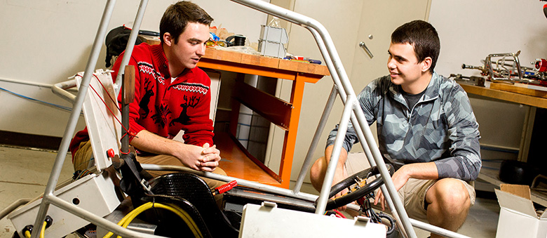 Ben Weiss and Connor McBride work on an electric go-kart for a student project.