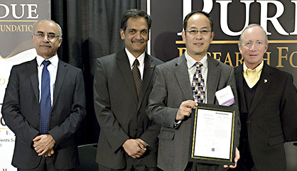 Qingyou Han, third from left, is honored at the 2014 Inventors Recognition Reception. He was joined on the stage by Purdue administrators Deba Dutta, provost; Suresh Garimella, executive vice president for research and partnerships; and Mitch Daniels, president.