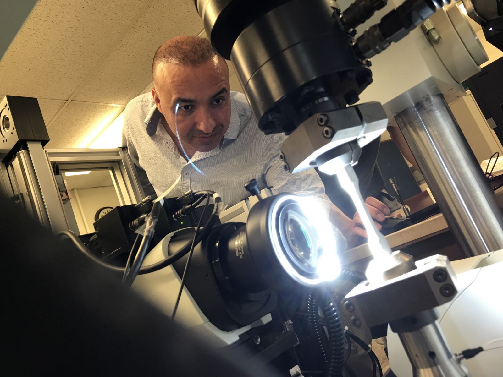 Ayhan Ince readies a metal sample for high cycle fatigue testing. (Purdue University photo/John O'Malley)