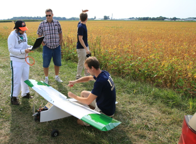 Corben Meyer prepares a fixed wing, autonomous aircraft for data acquisition with hyperspectral camera. (Photo by Mike Butram)