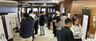 graduate students look at posters