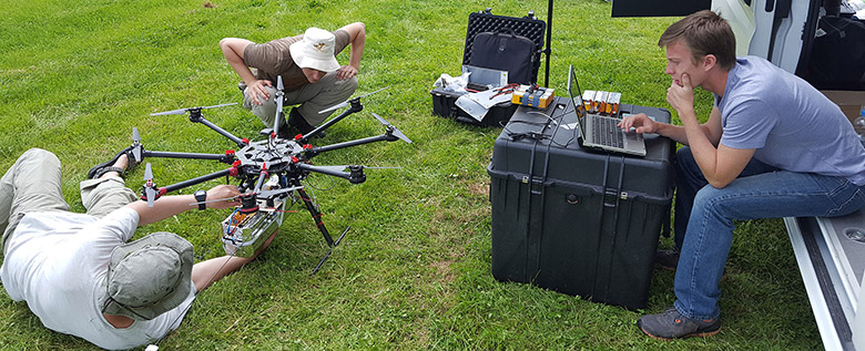 Evan Flatt, right, preps the UAV for a flight in Germany.