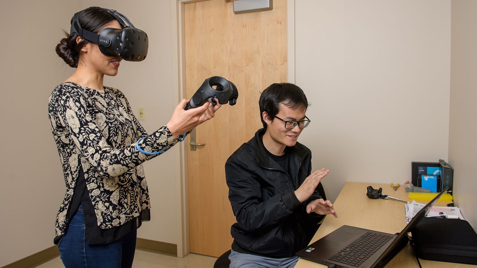 Purdue master’s student Jun Zhang, seated, and doctoral student Brenda Gonzalez demonstrate the CryoVR. The virtual reality training platform received a grant from the National Institute of Health. (Purdue University photo/Rebecca Wilcox)