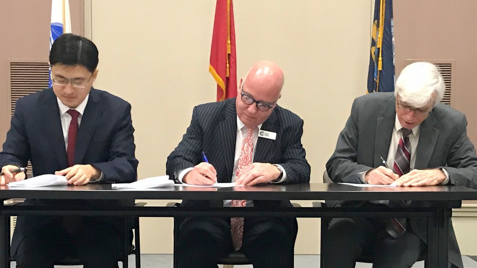 Purdue University is partnering with Cranfield University to jointly offer education programs that will support the U.S. Department of Defense and its allies. Pictured are Mung Chiang, Simon Pollard and Gary Bertoline. (Purdue University photo) 