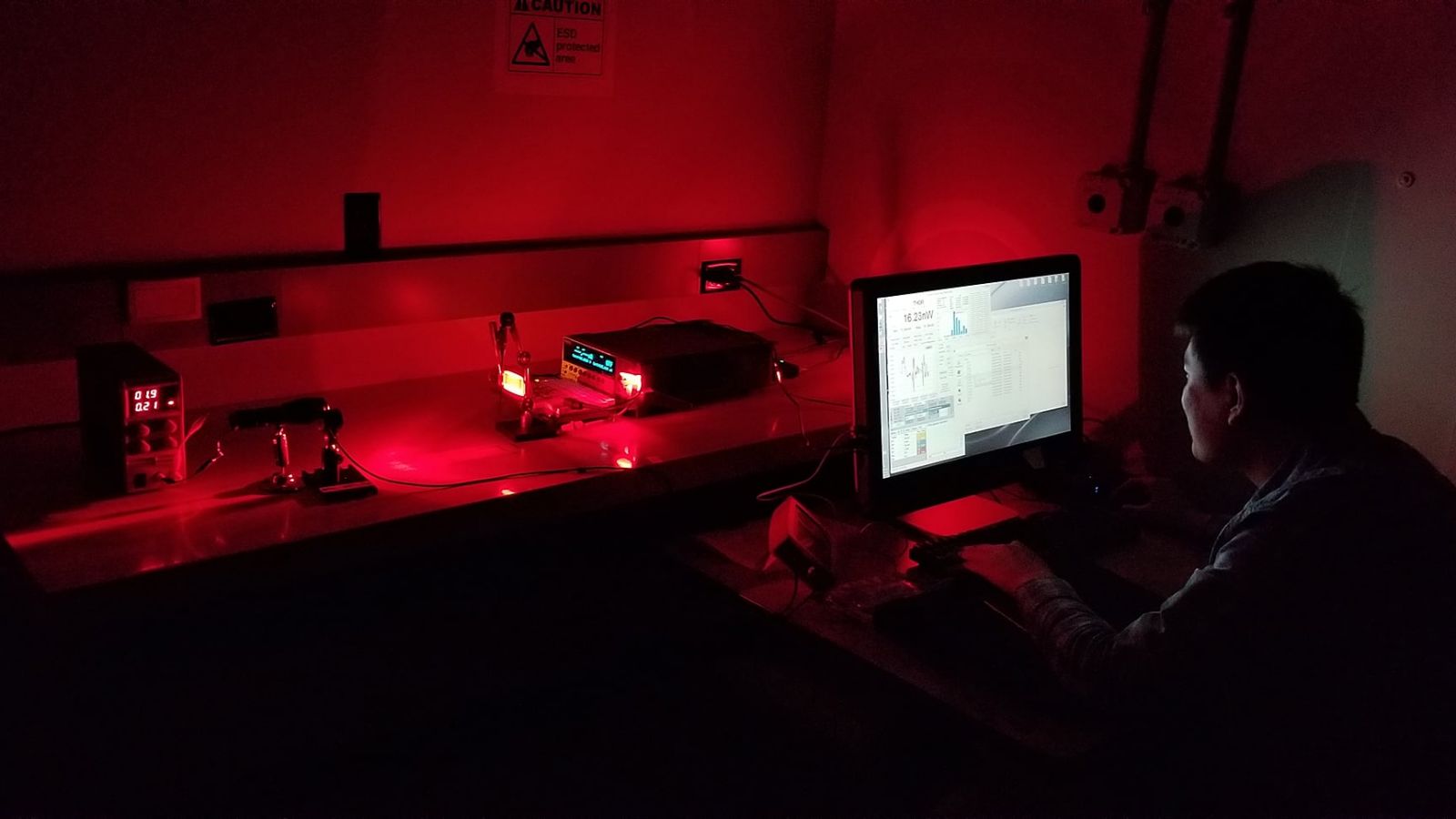 Purdue University graduate student Xiaozhe Fan measures how much light is emitted by a GaAs solar cell. The light emitted by the solar cell is modulated to convey information. (Image provided)