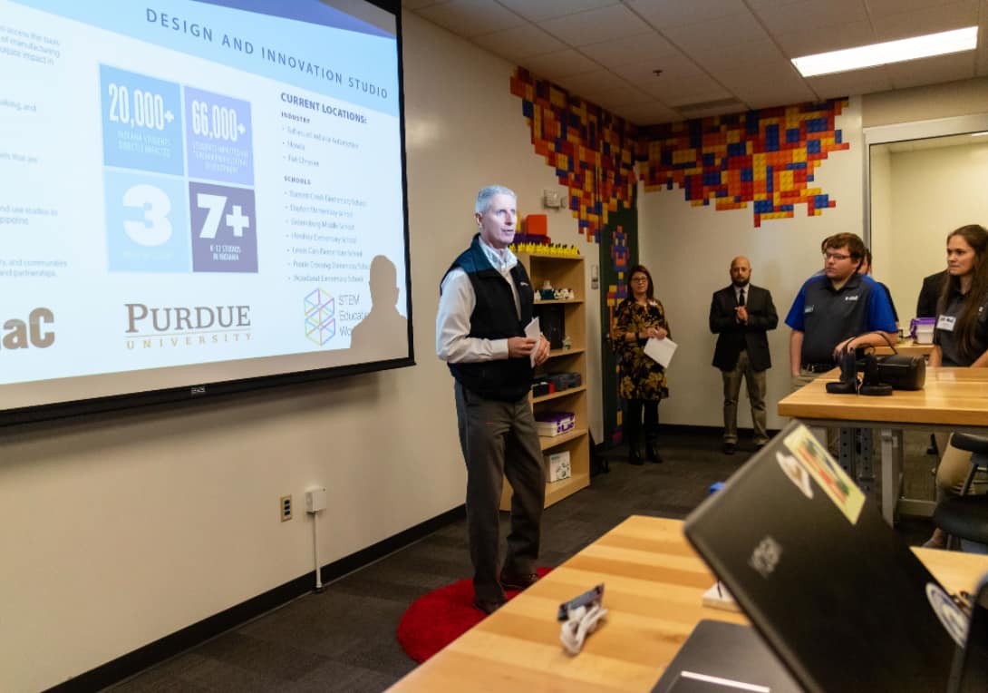 Scott Brand, senior vice president of administration and quality at Subaru of Indiana Automotive (SIA), speaks to attendees about the partnership between SIA and the IN-MaC Design and Innovation Studio at the IMI.  