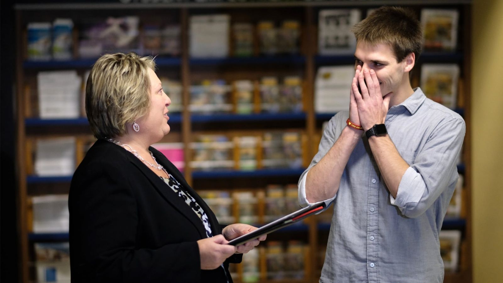 Kai Mangiaracina, at right, reacts to being told by Heidi A. Carl that his current Back a Boiler contract obligation would be cut in half to commemorate the program’s 1,000th contract. (Purdue Research Foundation photo/Oren Darling)