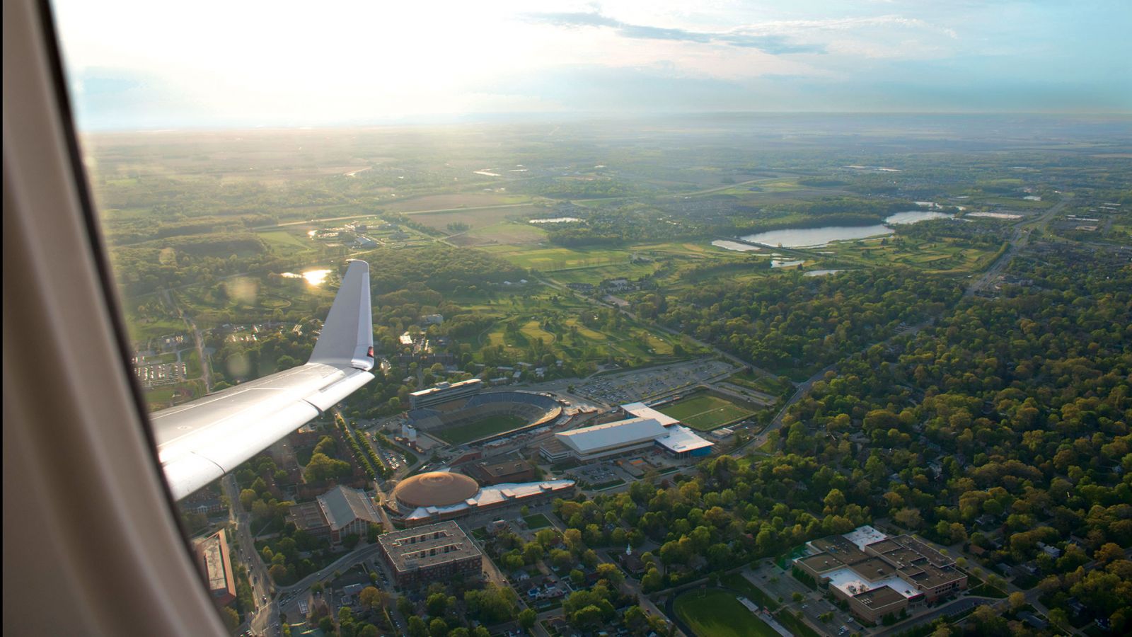 An aerial photo of Purdue's West Lafayette campus, featuring Ross-Ade Stadium and Mackey Arena