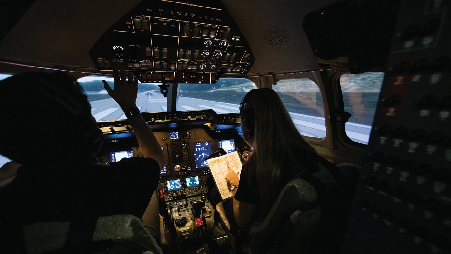 Professional flight students using the Hawker 900XP simulator