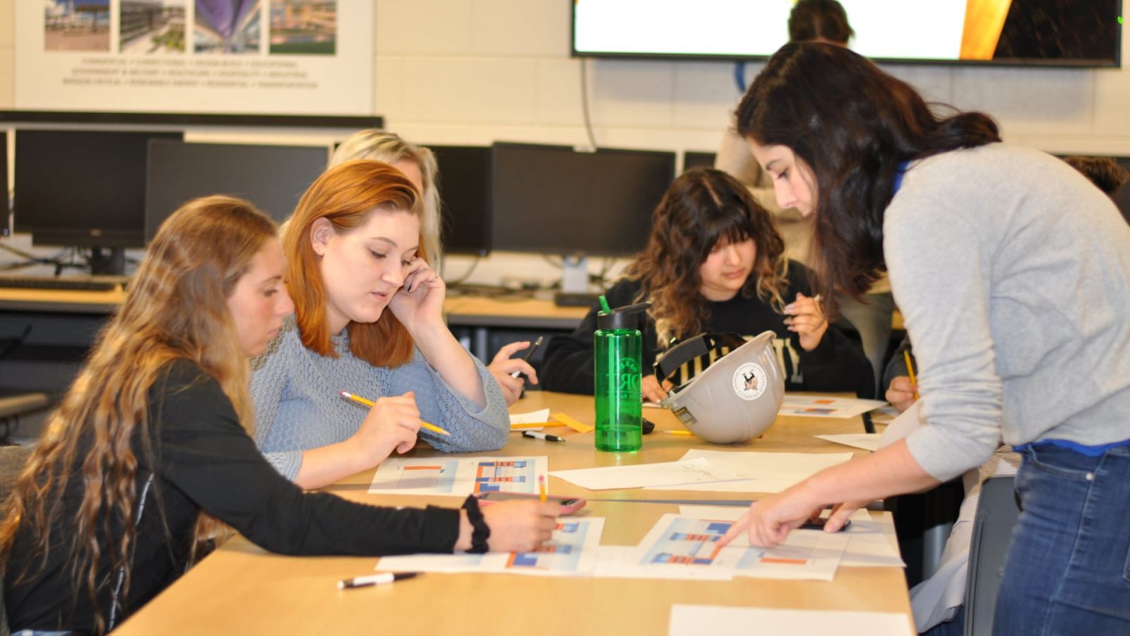 Luciana Debs (right), assistant professor of construction management technology, leads the Women in Construction Management student organization in a discussion about precast construction.