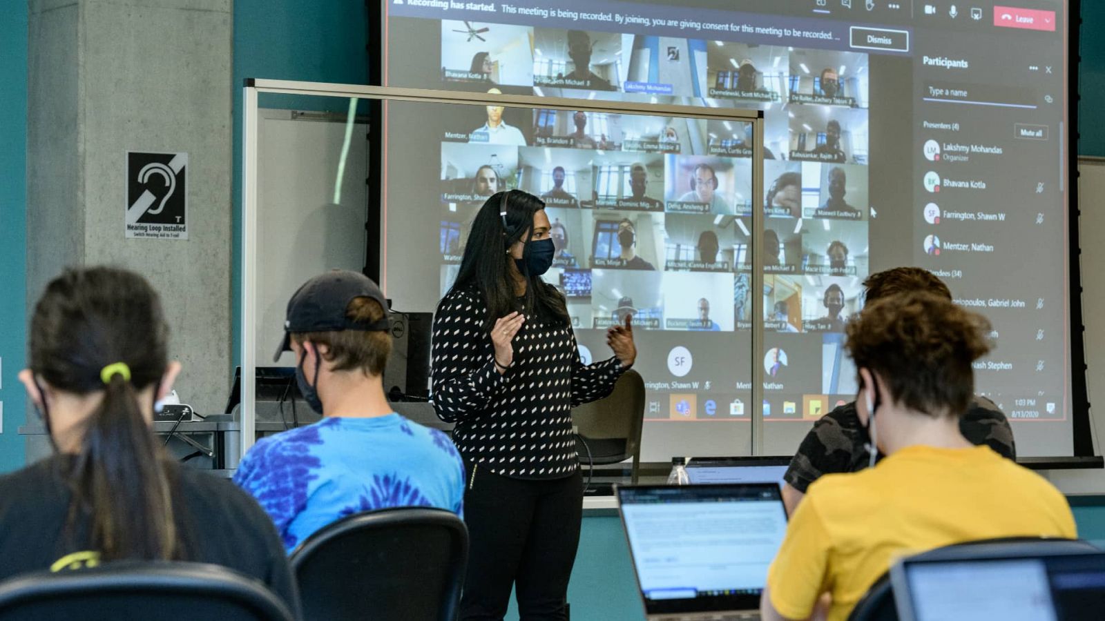 Graduate student Lakshmy Mohandas instructs Tech 120 students in person while Nathan Mentzer, associate professor of technology leadership and innovation, teaches online through Microsoft Teams at the same time. The blend of both face-to-face and online instruction, also known as a HyFlex model, give students the option to stay home and participate in class in real-time online or physically attend on any given day. (Purdue University photo/John Underwood)
