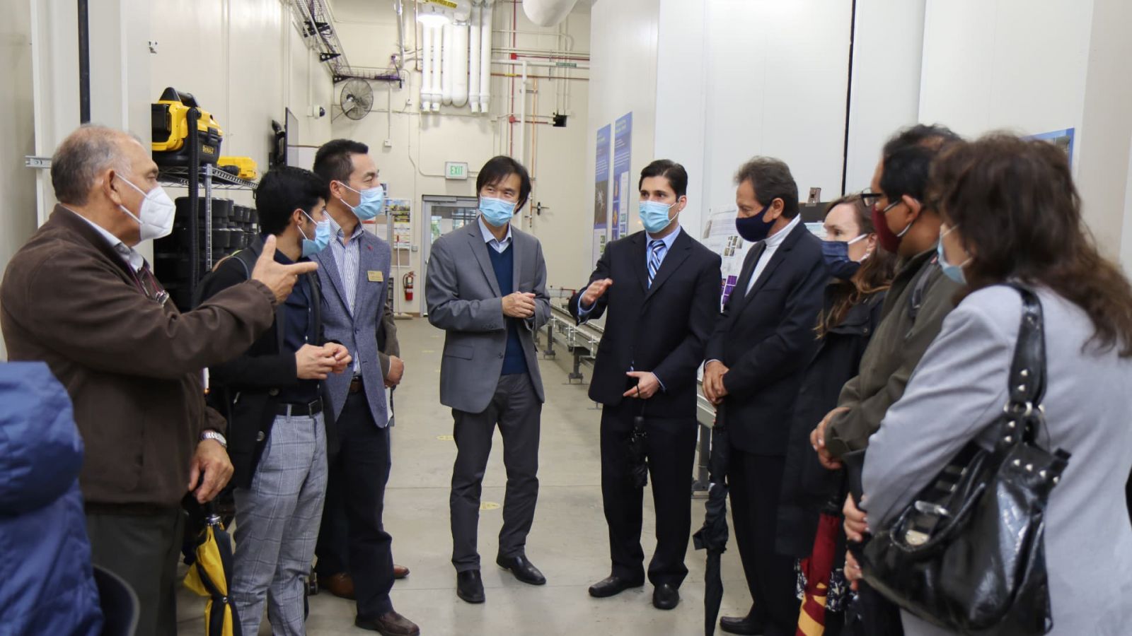 Daniel Leon-Salas (center-right), associate professor of engineering technology, and other Purdue professors give a tour of Purdue’s Ag Alumni Seed Phenotyping Facility to a delegation of visitors from the Universidad Nacional de San Agustín (UNSA) in Arequipa, Peru. (Purdue University photo/John O’Malley)