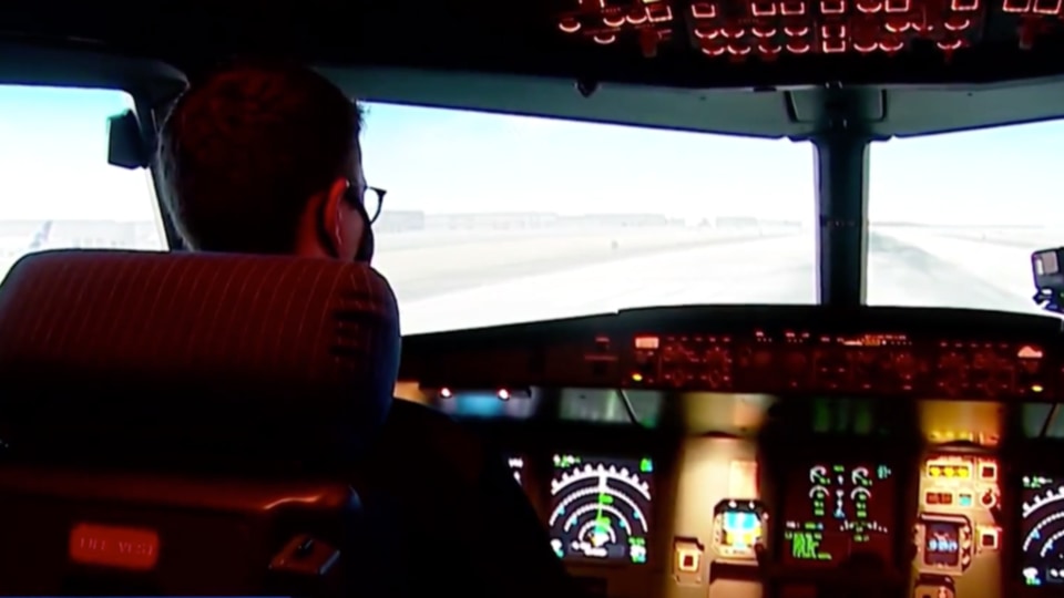 Adam Dunham, a master's student and flight instructor, flies in one of the School of Aviation and Transportation Technology's flight simulators.