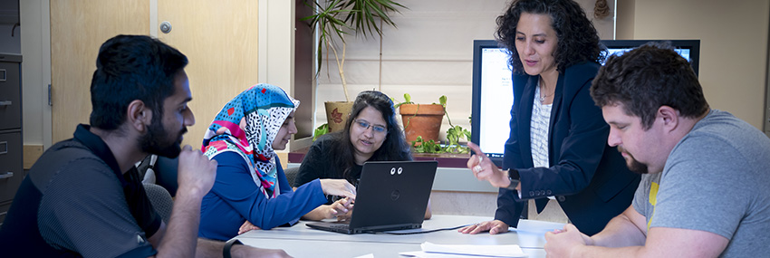 Alejandra Magana (standing), collaborating with graduate research assistants. (Photo provided)