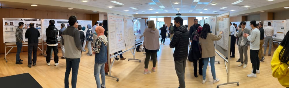 Students, faculty and staff discuss Purdue Polytechnic research projects in Stewart Center.