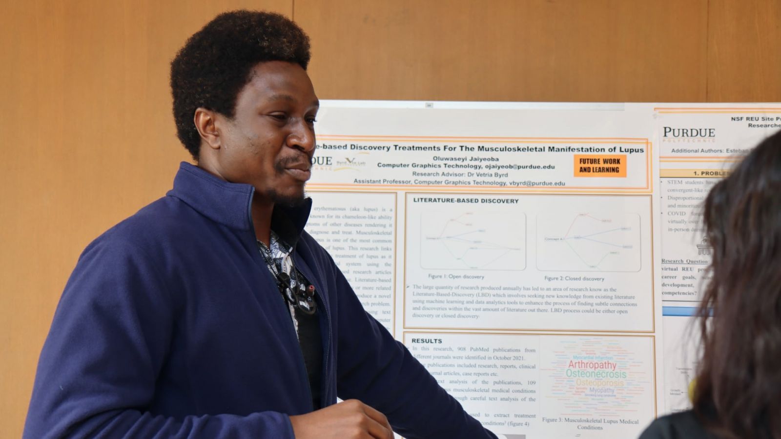 Oluwaseyi Jaiyeoba, graduate research assistant in Purdue Polytechnic's Department of Computer Graphics Technology, presents his research, “Literature-based Discovery Treatments for The Musculoskeletal Manifestation of Lupus” (Purdue University photo/John O'Malley)