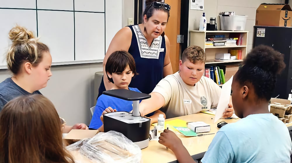 Food Engineer Adventure camp participants work on assembling their aerogarden. (The Herald Bulletin photo/John P. Cleary)