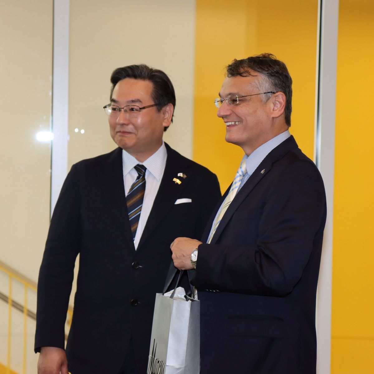 Consul-General Tajima exchanges a gift with Daniel Castro, dean of Purdue Polytechnic, during a tour of Dudley and Lambertus Halls. (Purdue University photo/John O'Malley)