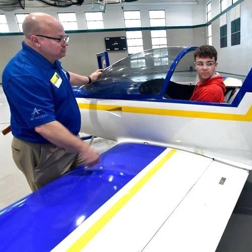 Jaxton Bush sits in an airplane as he talks to Vincennes University Director of Aviation Michael Dennis Gehrich. (Photo Credit: Richard Sitler for The Herald Bulletin)